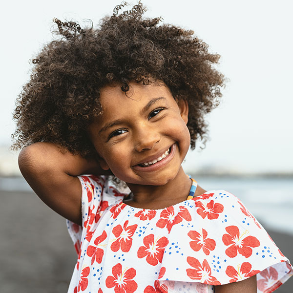 Young Girl Smiling with her arm behind her back